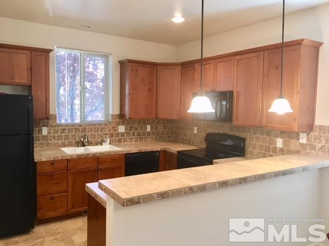 3677 A Warren Way Reno, NV 89509 - Photo 6 of 10 a kitchen with a sink a refrigerator and a stove