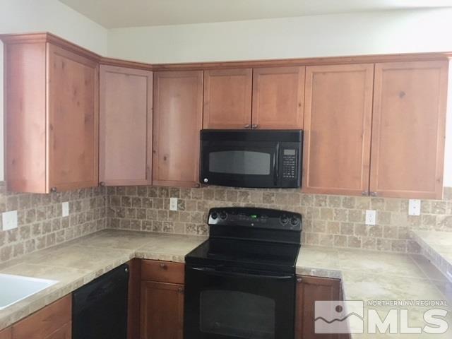 3677 A Warren Way Reno, NV 89509 - Photo 7 of 10 a kitchen with a sink a stove and cabinets