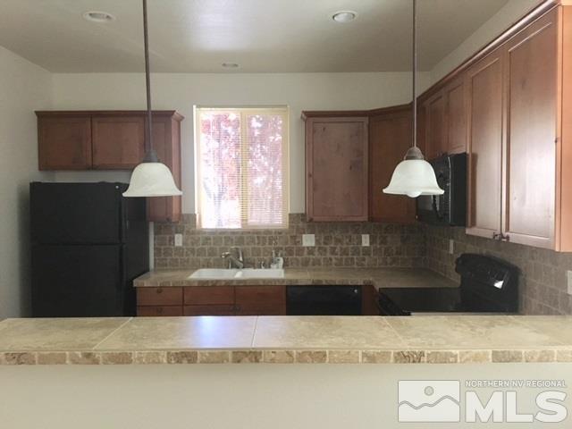 3677 A Warren Way Reno, NV 89509 - Photo 8 of 10 a kitchen with a sink and a mirror