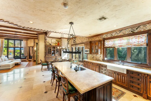 a kitchen with sink and view of living room