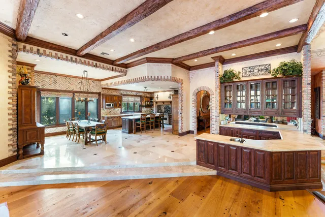 a view of a kitchen with kitchen island granite countertop lots of counter top space
