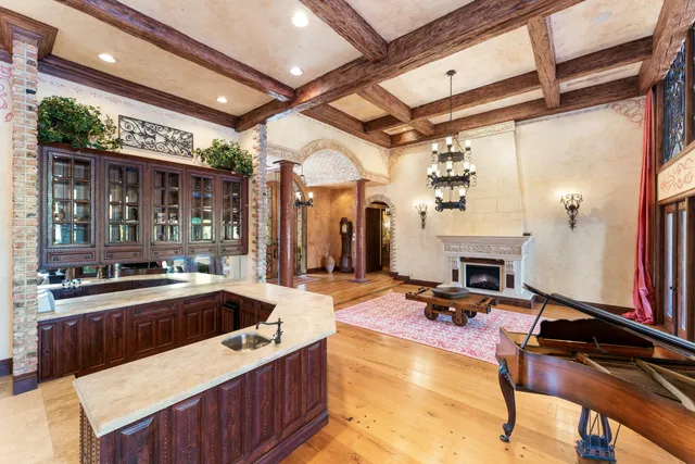 a living room with furniture a rug and a chandelier