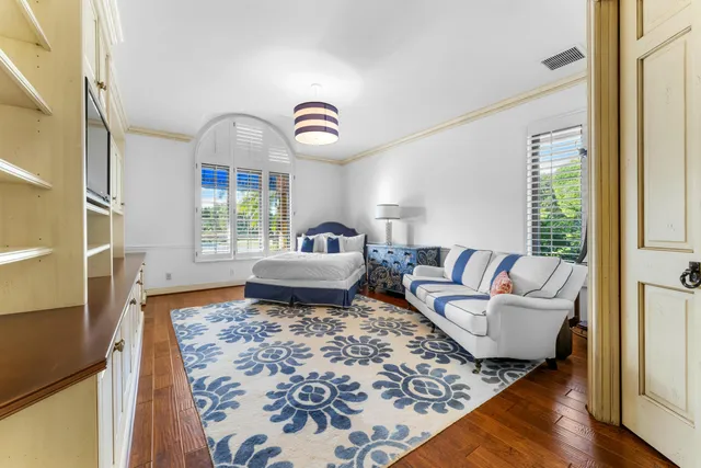 a bedroom with a large bed and a chandelier