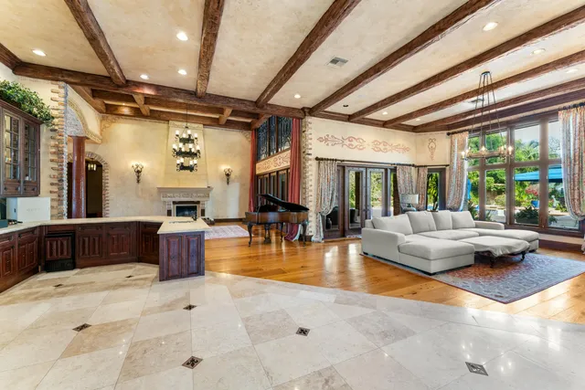 a dining room with furniture and a large window