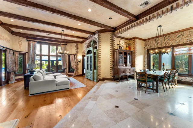 a large kitchen with stainless steel appliances granite countertop a stove and a view of living room