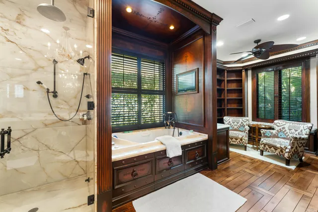 a spacious bedroom with bed and a chandelier