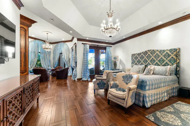 a view of a dining room with furniture a chandelier and wooden floor