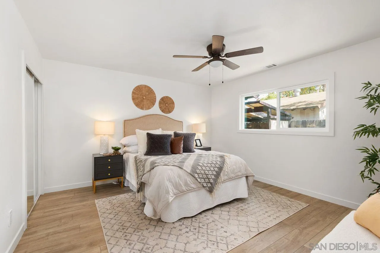12914 Morene Street Poway, CA 92064 - Photo 17 of 40 a bedroom with a bed and wooden floor