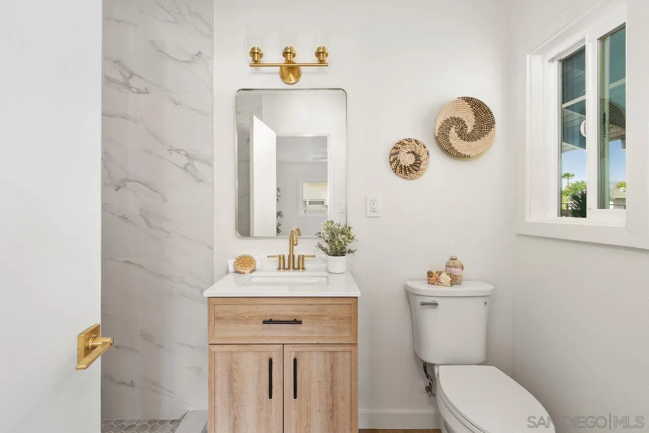 12914 Morene Street Poway, CA 92064 - Photo 20 of 40 a bathroom with a toilet sink and mirror