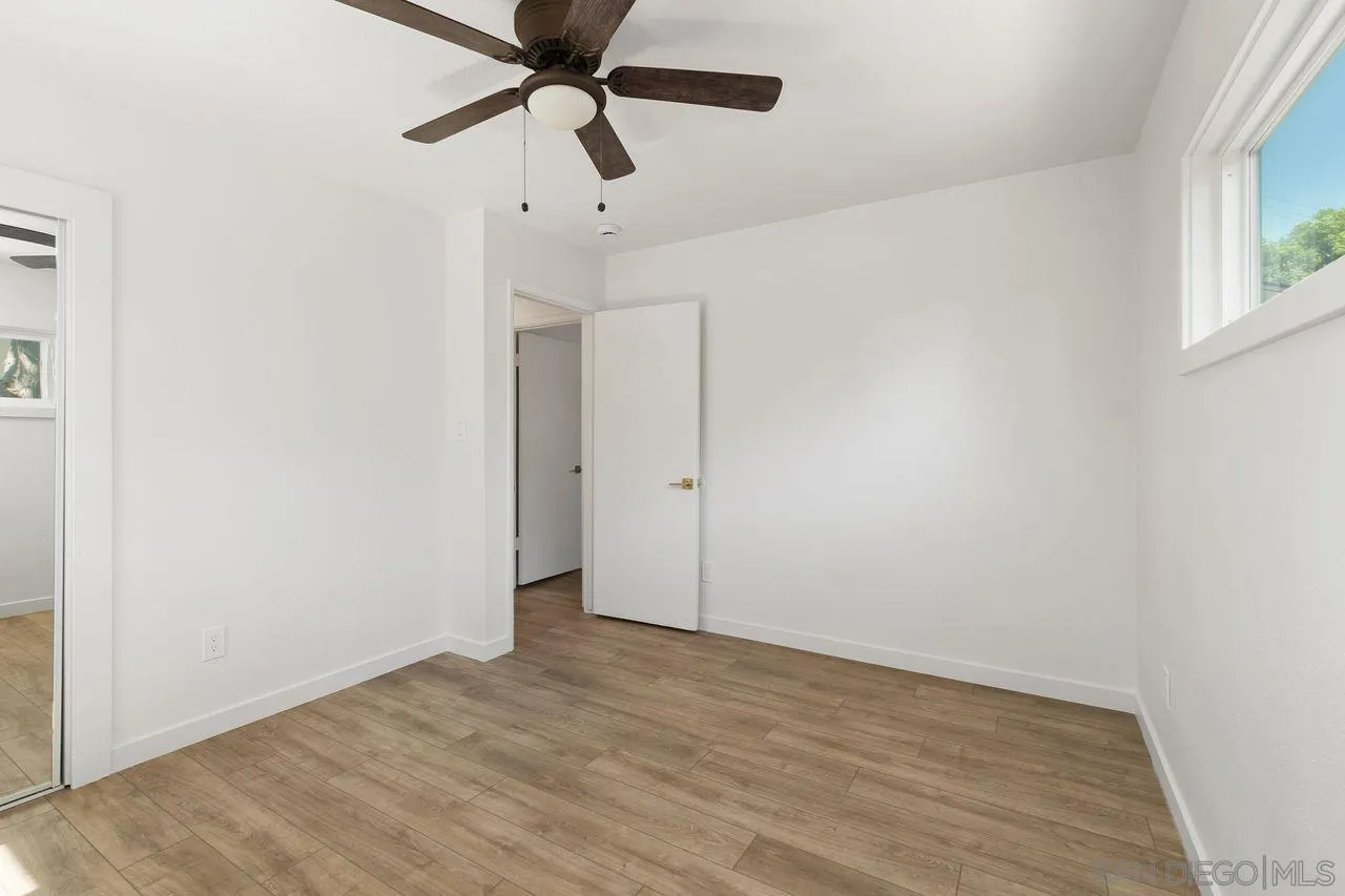 12914 Morene Street Poway, CA 92064 - Photo 22 of 40 an empty room with a ceiling fan and window