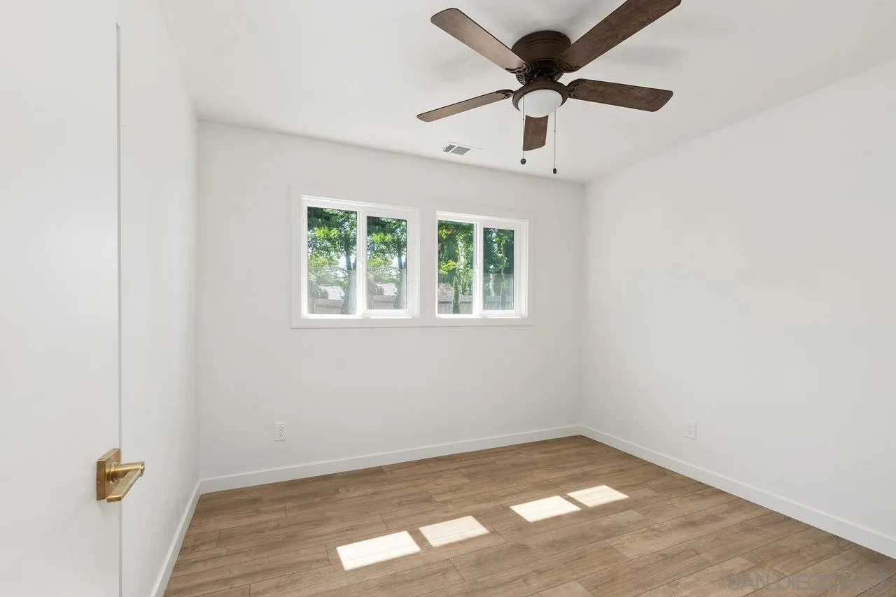 12914 Morene Street Poway, CA 92064 - Photo 23 of 40 an empty room with a window and a ceiling fan