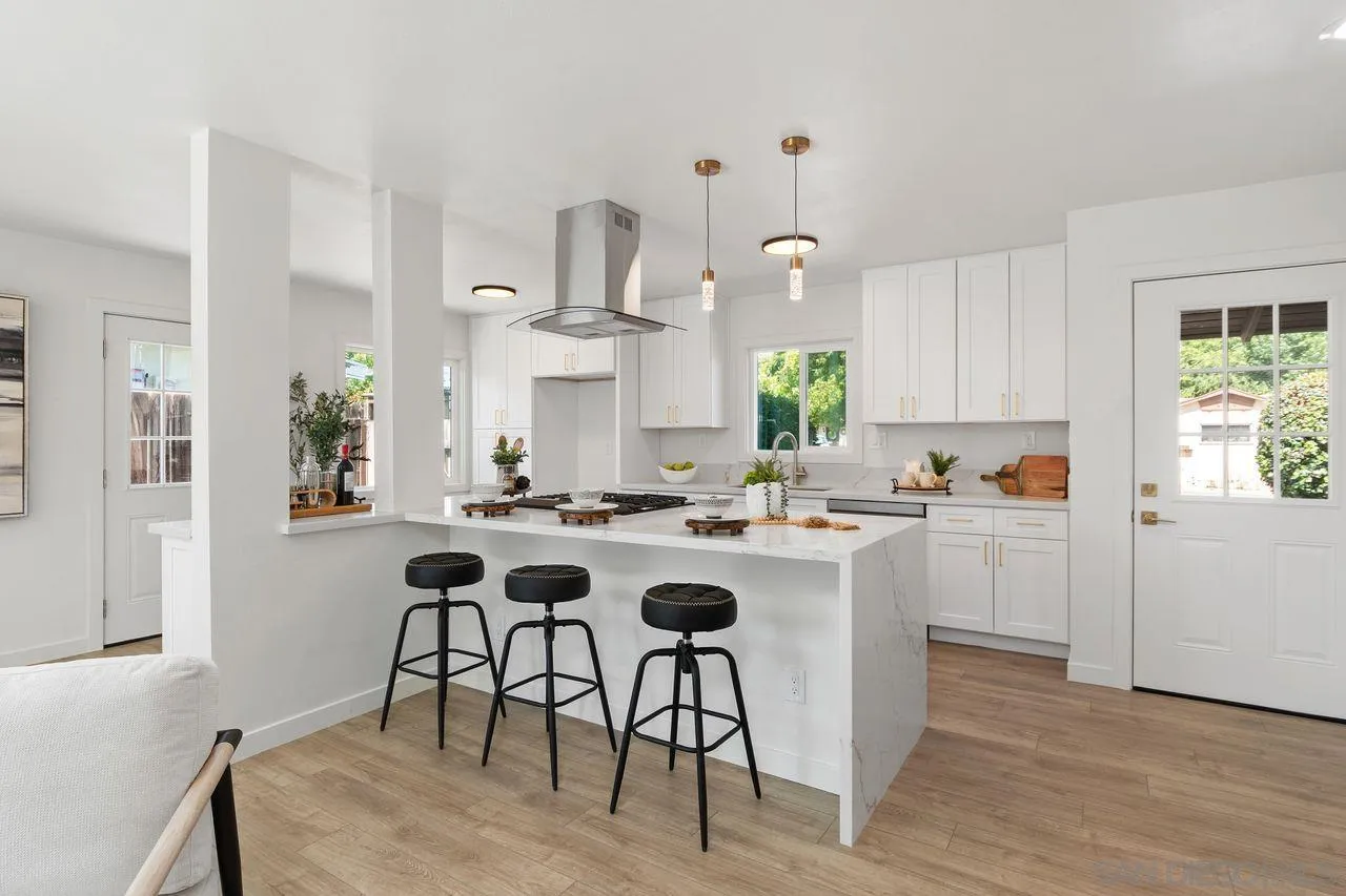 12914 Morene Street Poway, CA 92064 - Photo 7 of 40 a kitchen with white cabinets and stainless steel appliances