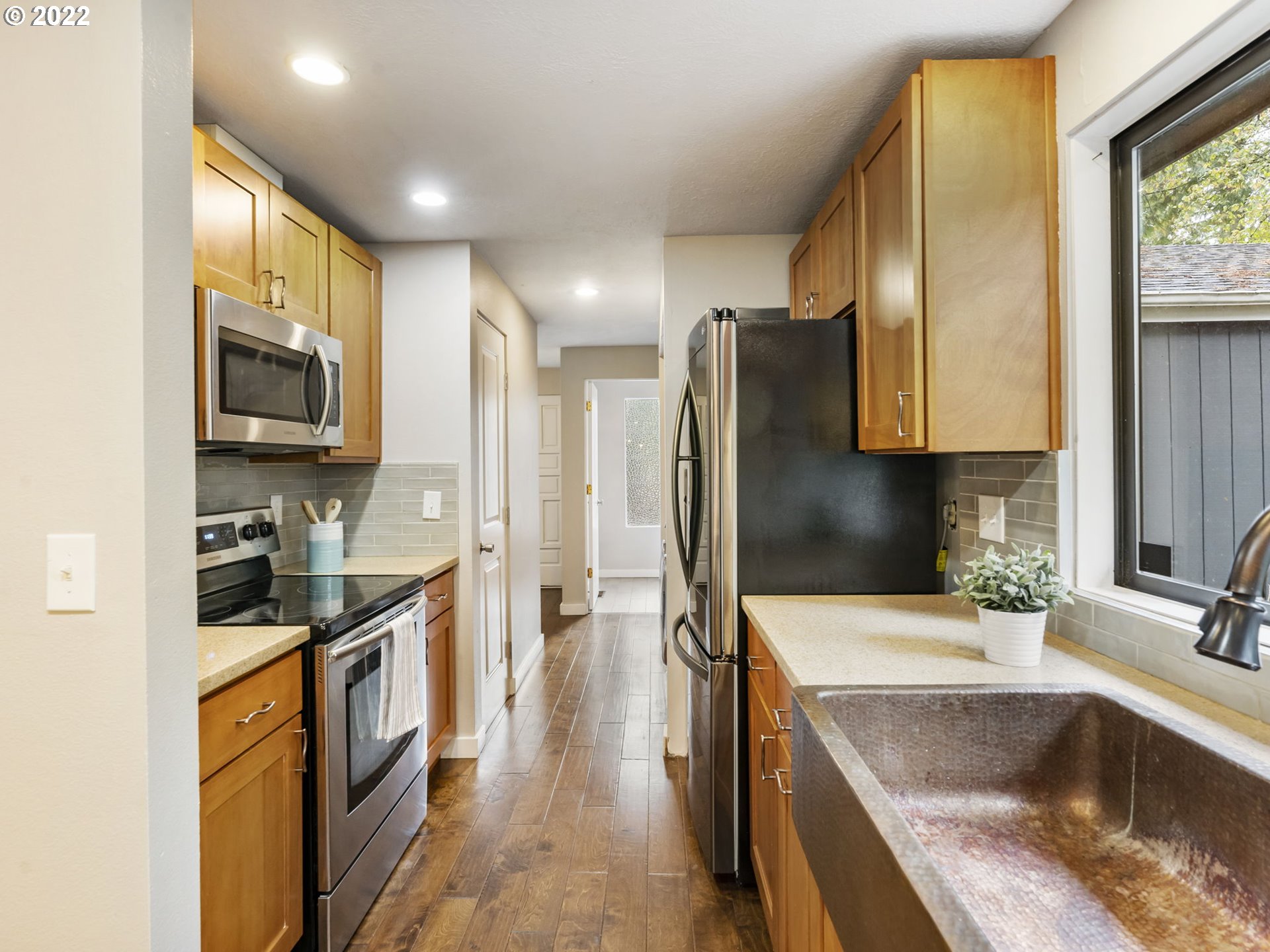 10029 Southwest 52nd Avenue Portland, OR 97219 - Photo 11 of 31 a kitchen with stainless steel appliances granite countertop a sink a stove and a refrigerator