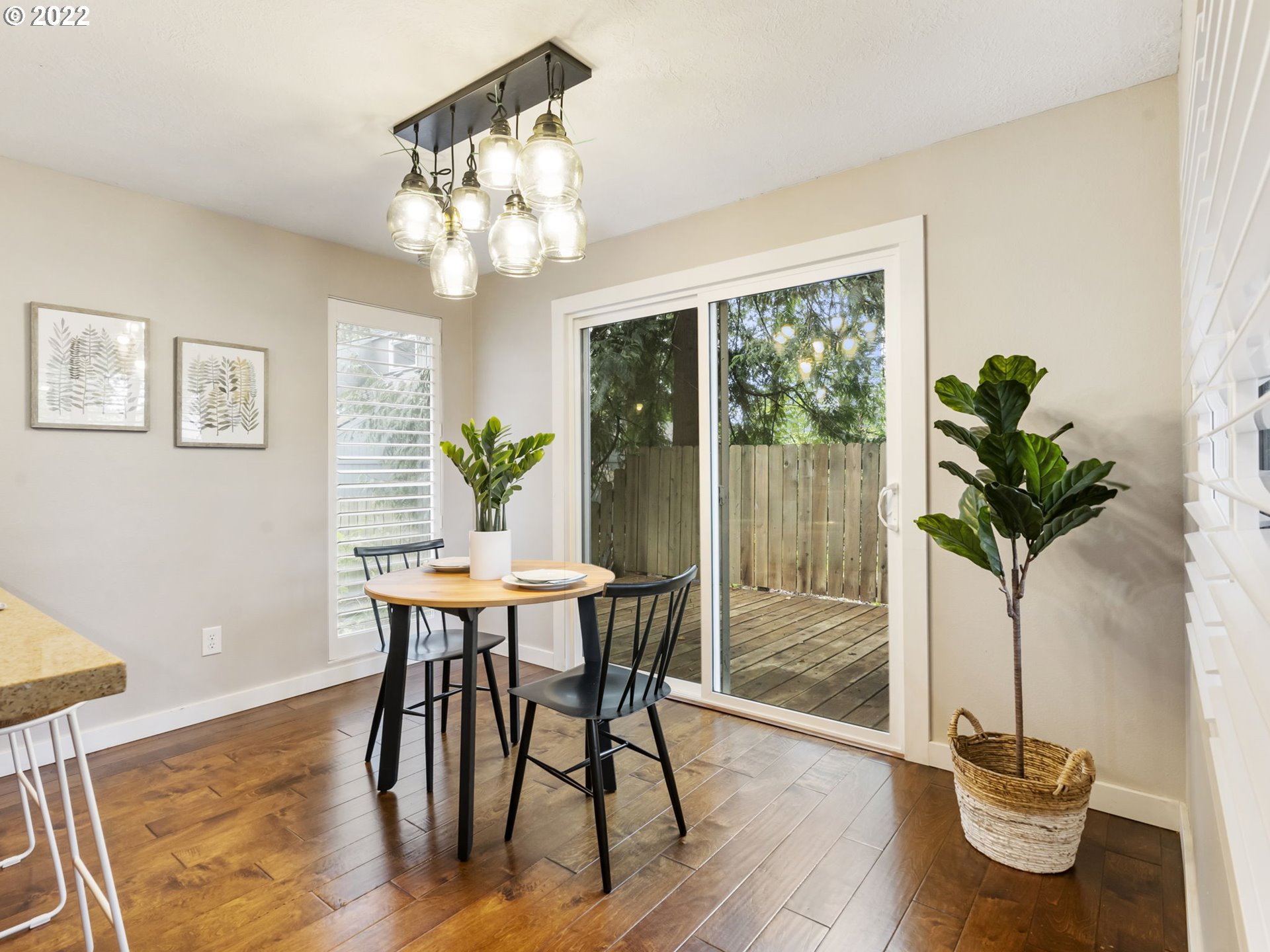 10029 Southwest 52nd Avenue Portland, OR 97219 - Photo 13 of 31 a dining room with furniture a potted plant and a chandelier