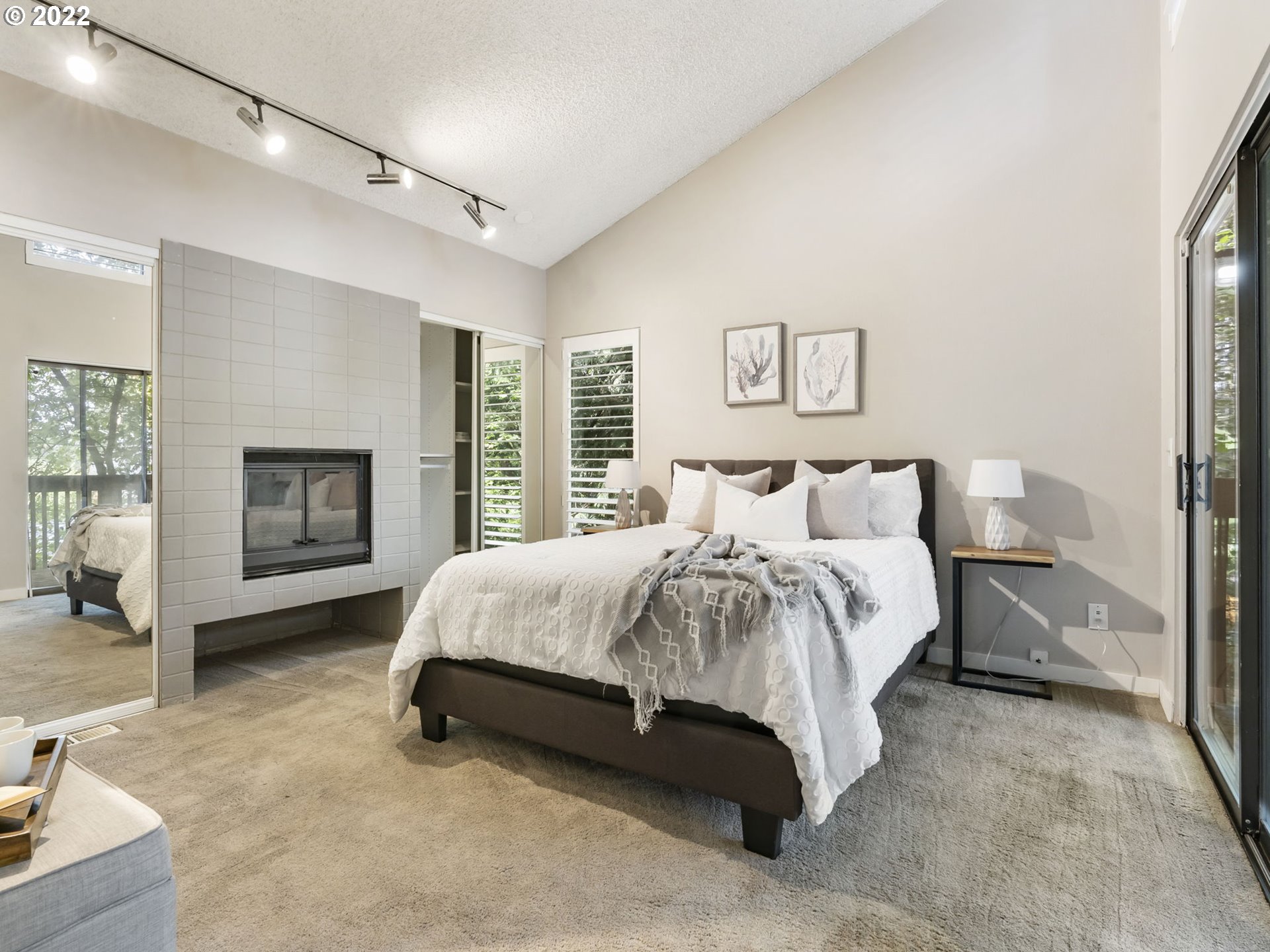 10029 Southwest 52nd Avenue Portland, OR 97219 - Photo 16 of 31 a spacious bedroom with a bed and a couch