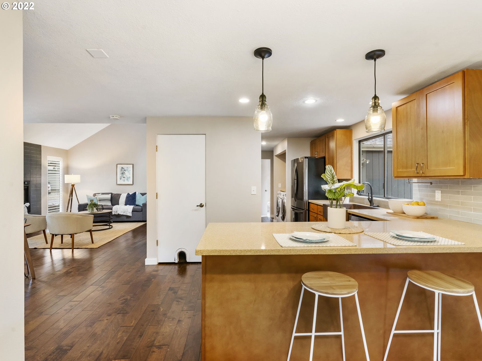 10029 Southwest 52nd Avenue Portland, OR 97219 - Photo 10 of 31 a large kitchen with kitchen island a stove a sink a center island and couches