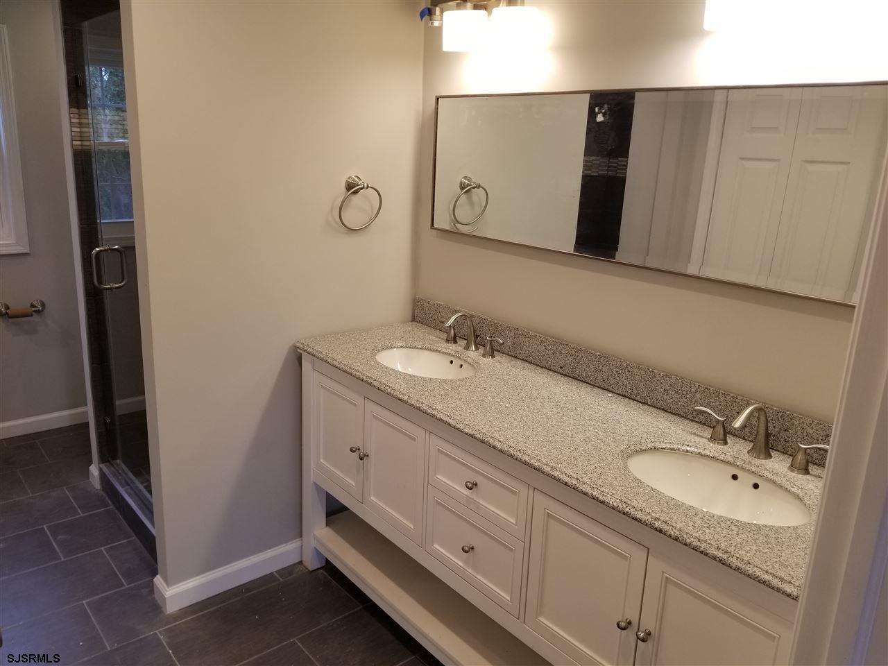 161 East Wyoming Avenue Absecon, NJ 08201 - Photo 11 of 18 a bathroom with a double vanity sink and mirror