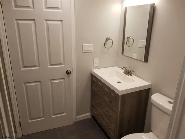 a view of bathroom with a sink and mirror