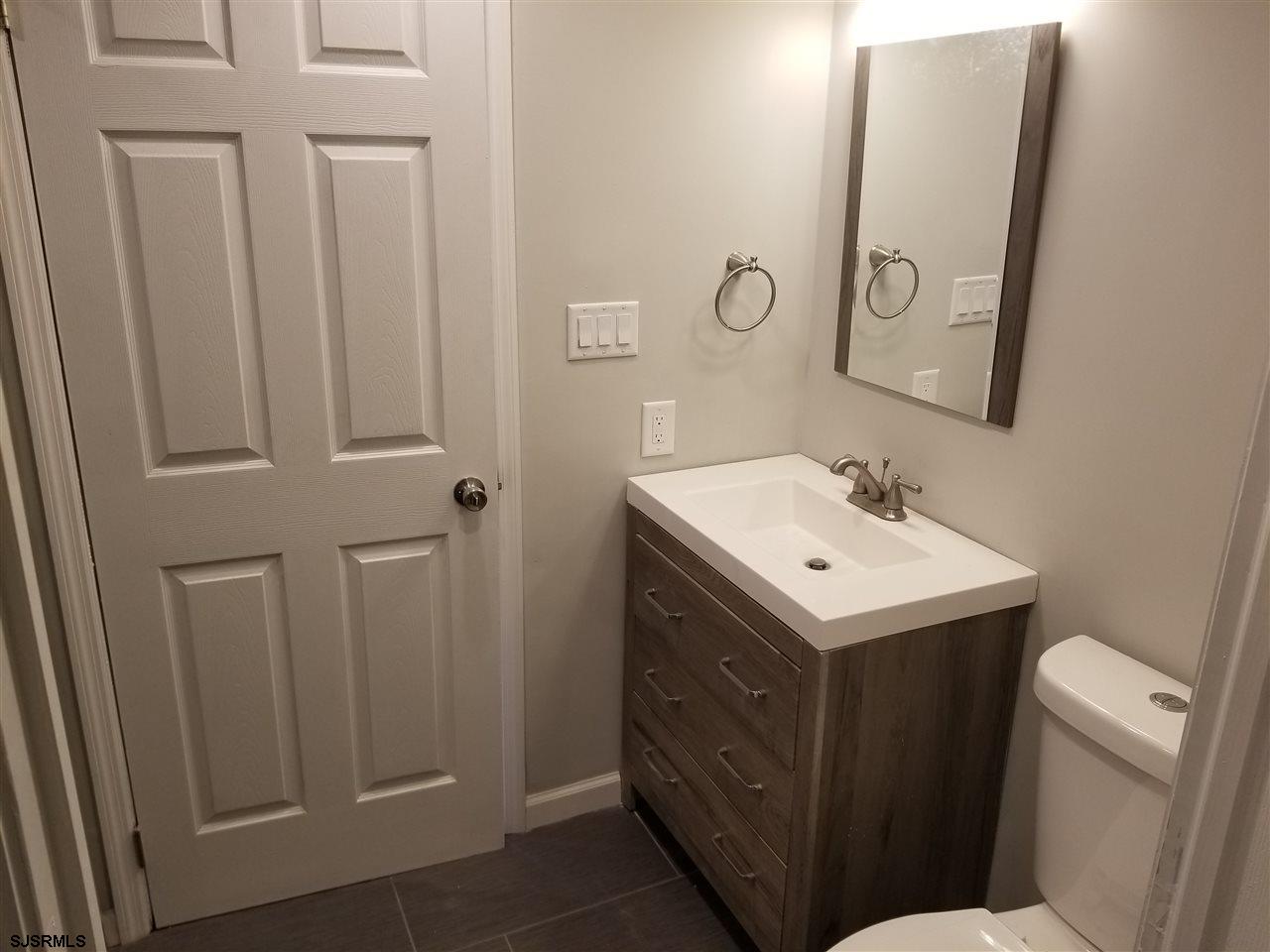 161 East Wyoming Avenue Absecon, NJ 08201 - Photo 12 of 18 a view of bathroom with a sink and mirror