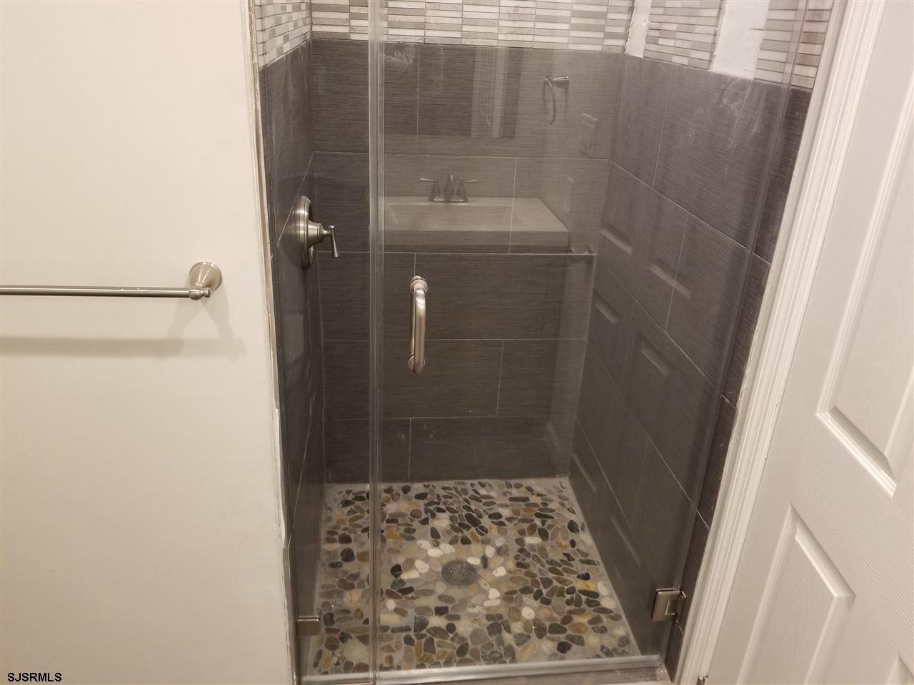 161 East Wyoming Avenue Absecon, NJ 08201 - Photo 13 of 18 a bathroom with a shower