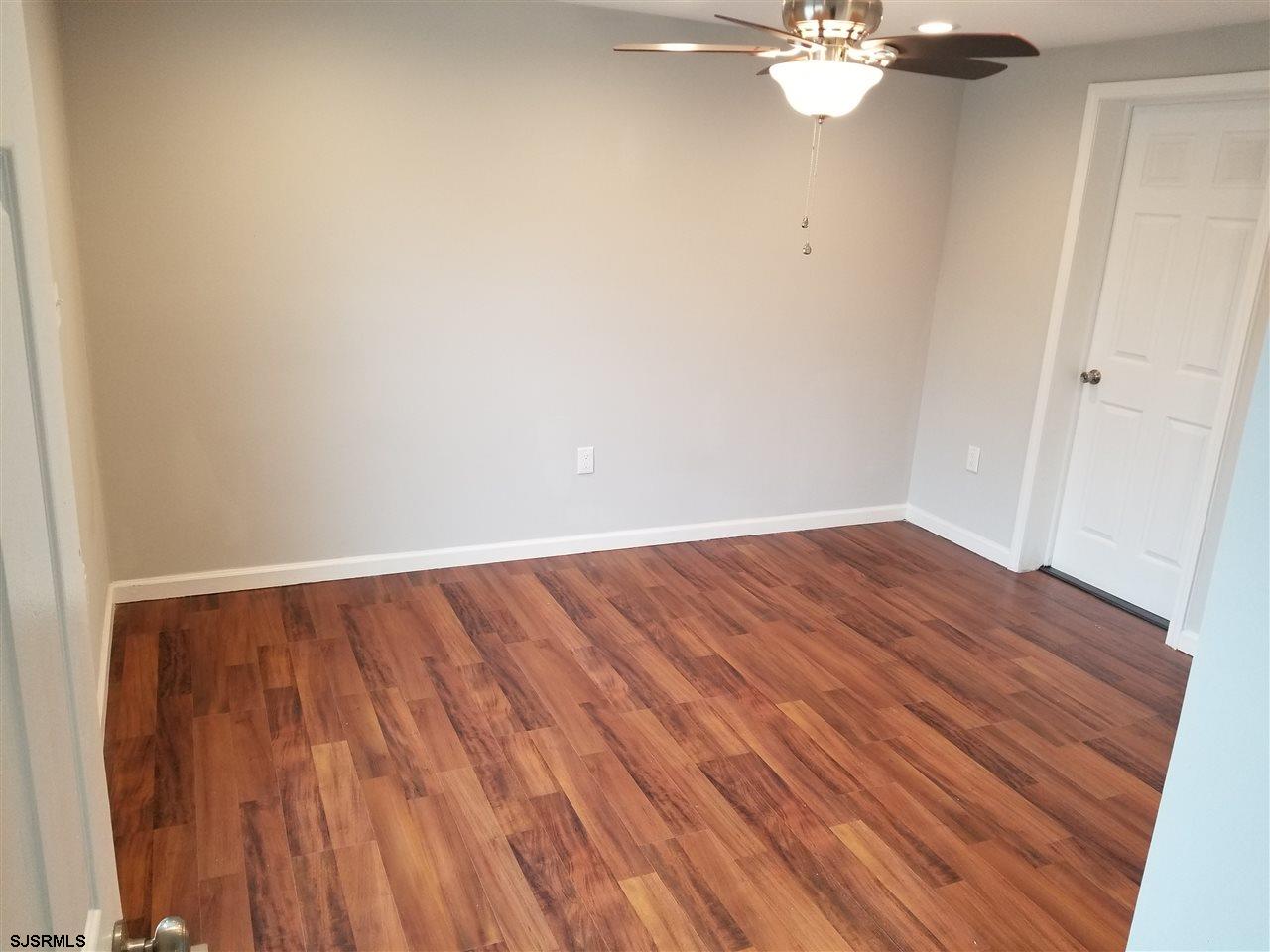 161 East Wyoming Avenue Absecon, NJ 08201 - Photo 14 of 18 a view of a room with wooden floor and fan