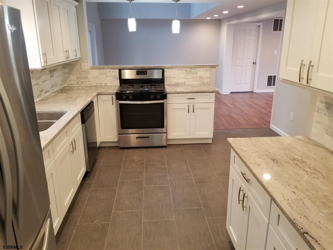 161 East Wyoming Avenue Absecon, NJ 08201 - Photo 8 of 18 a kitchen with a sink and a stove top oven