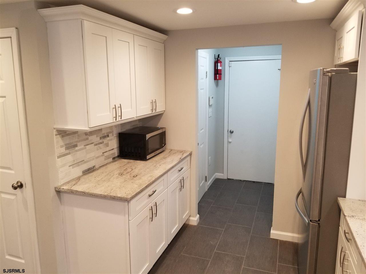 161 East Wyoming Avenue Absecon, NJ 08201 - Photo 9 of 18 a utility room with cabinets washer and dryer