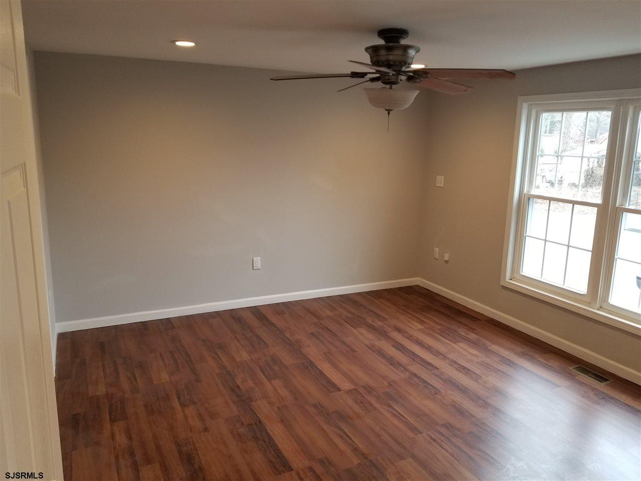 161 East Wyoming Avenue Absecon, NJ 08201 - Photo 10 of 18 wooden floor in an empty room with a window