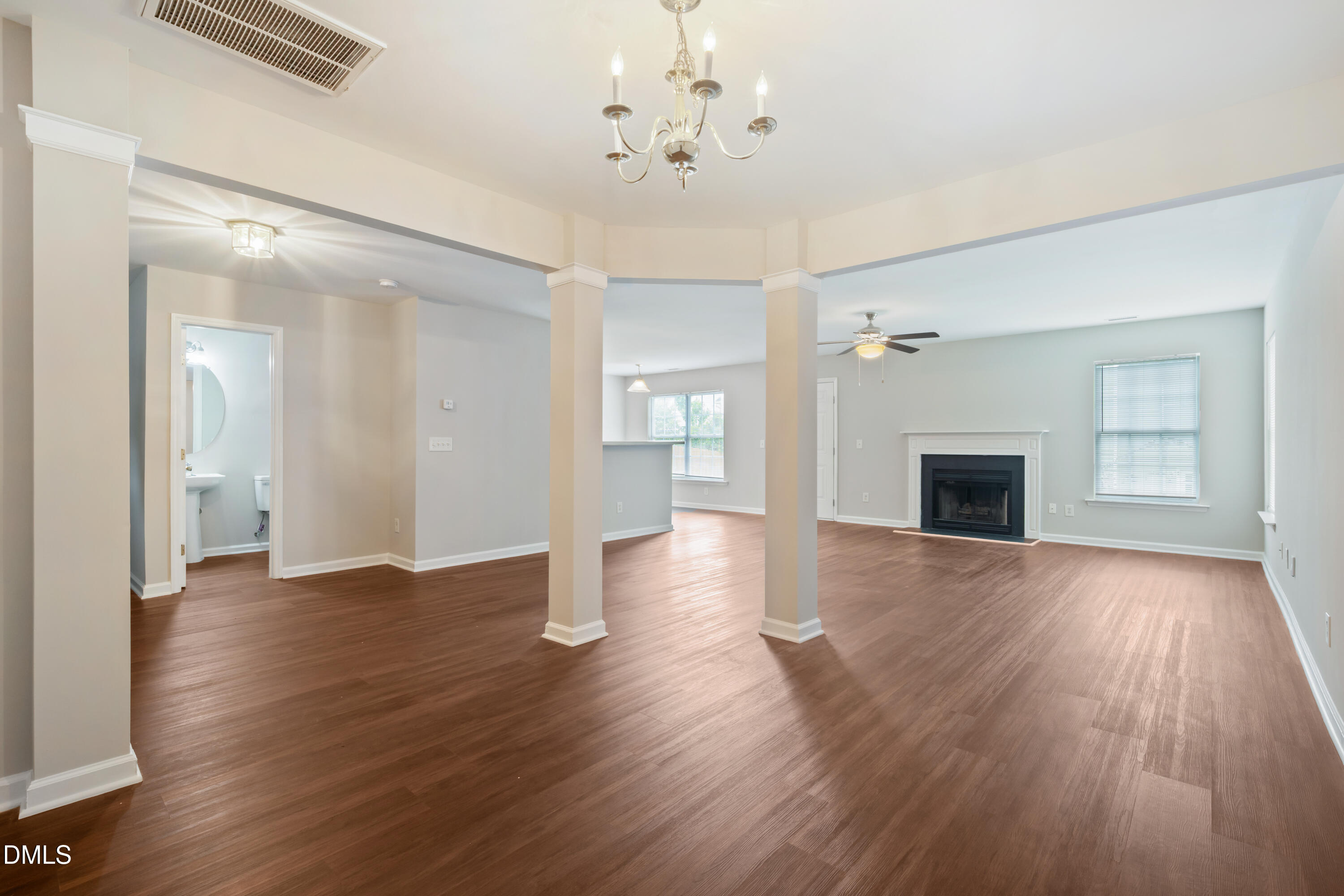 1532 Pebble Ridge Drive Raleigh, NC 27610 - Photo 8 of 40 a view of an empty room with wooden floor and a ceiling fan