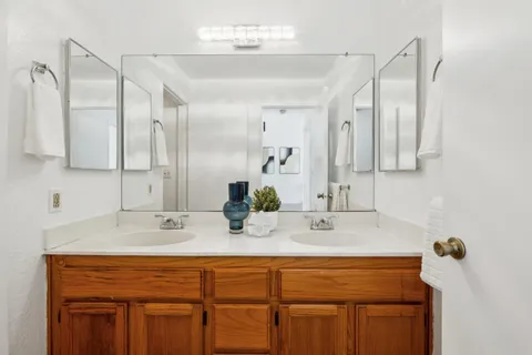 a bathroom with a sink double vanity and a mirror