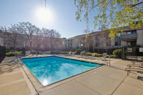 a view of swimming pool with outdoor seating and plants