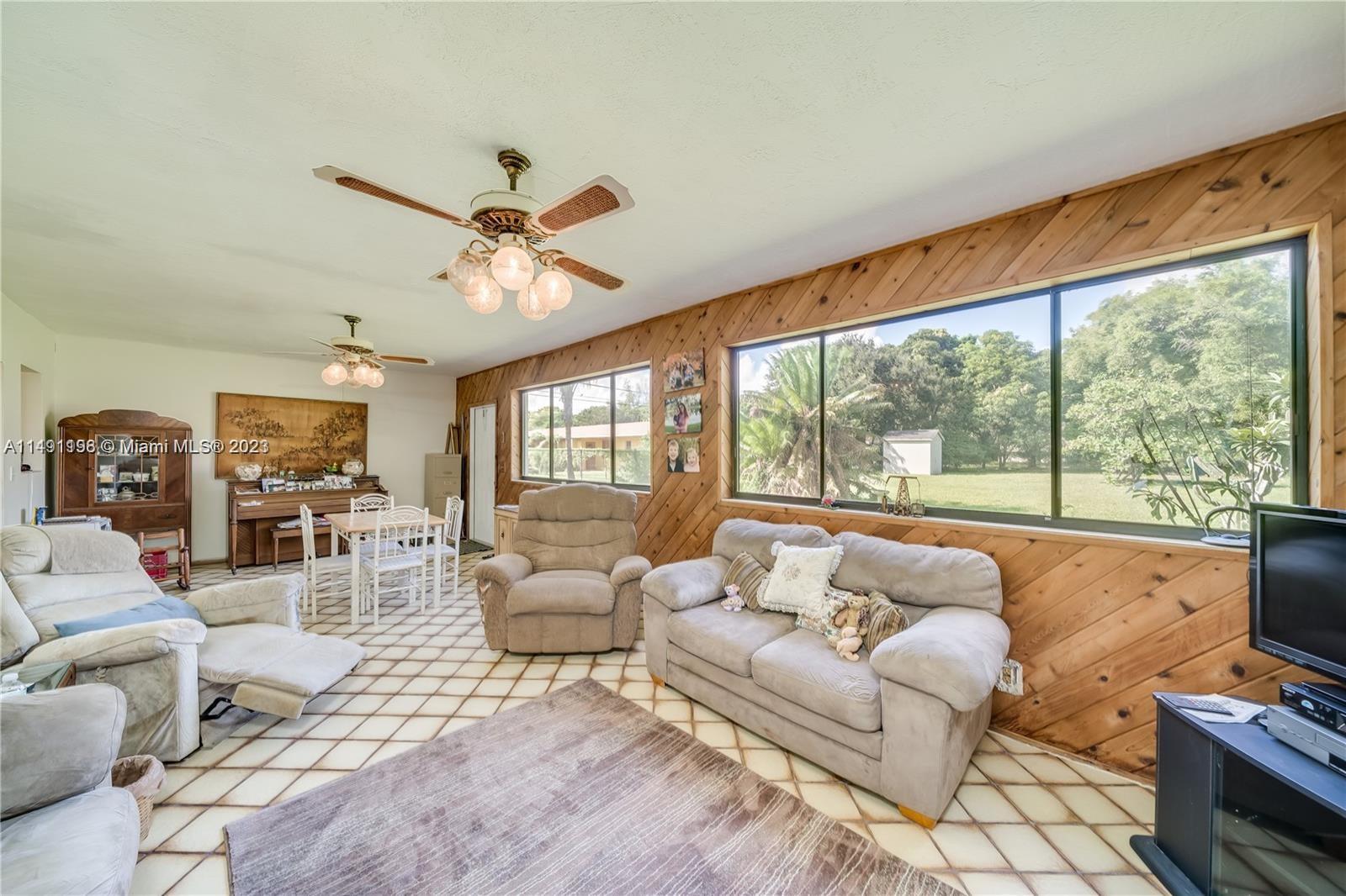 5709 McKinley Street Hollywood, FL 33021 - Photo 28 of 33 a living room with furniture and large windows