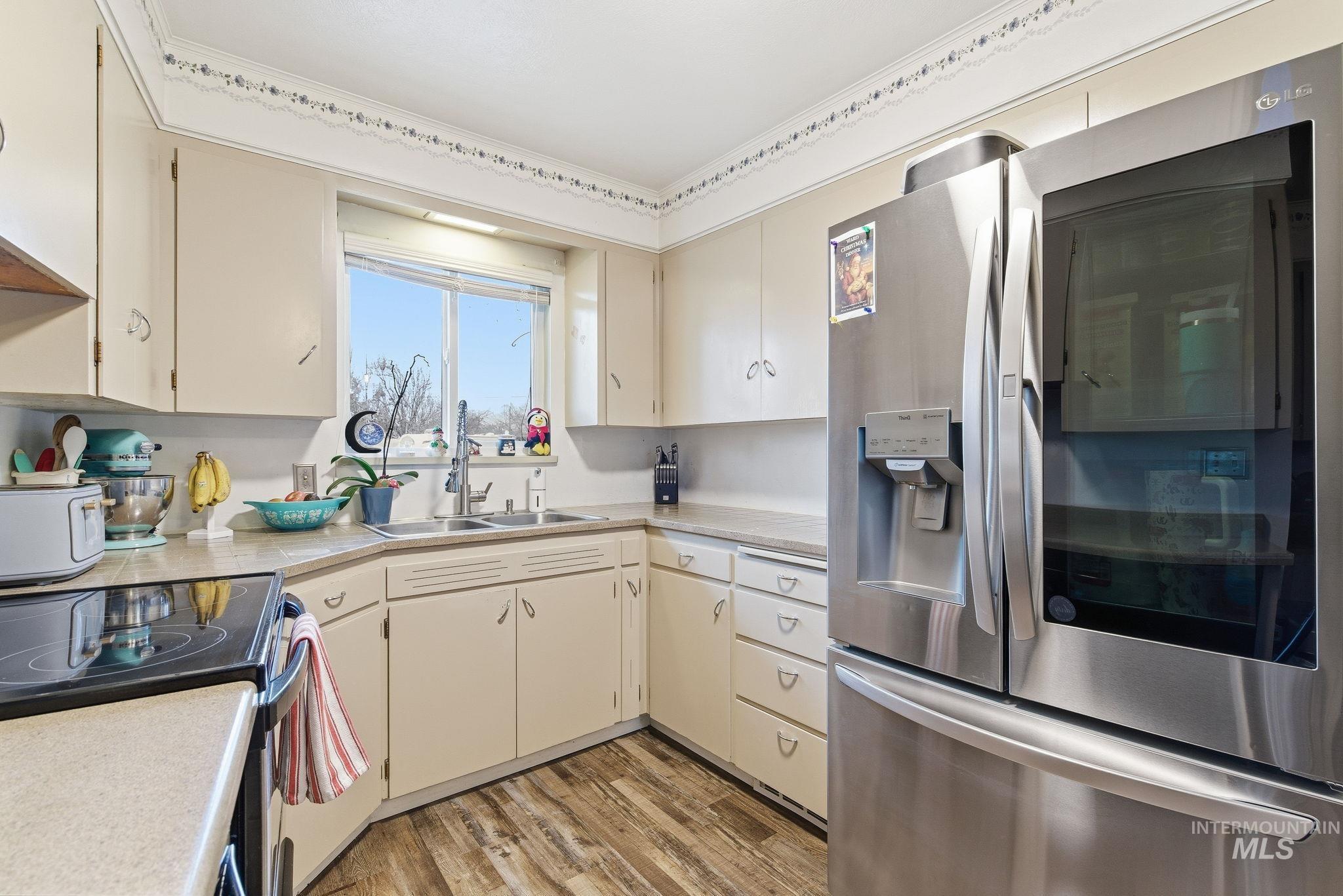 4426 West Clark Street Boise, ID 83705 - Photo 11 of 43 Kitchen with light countertops, appliances with stainless steel finishes, and light wood-style floors