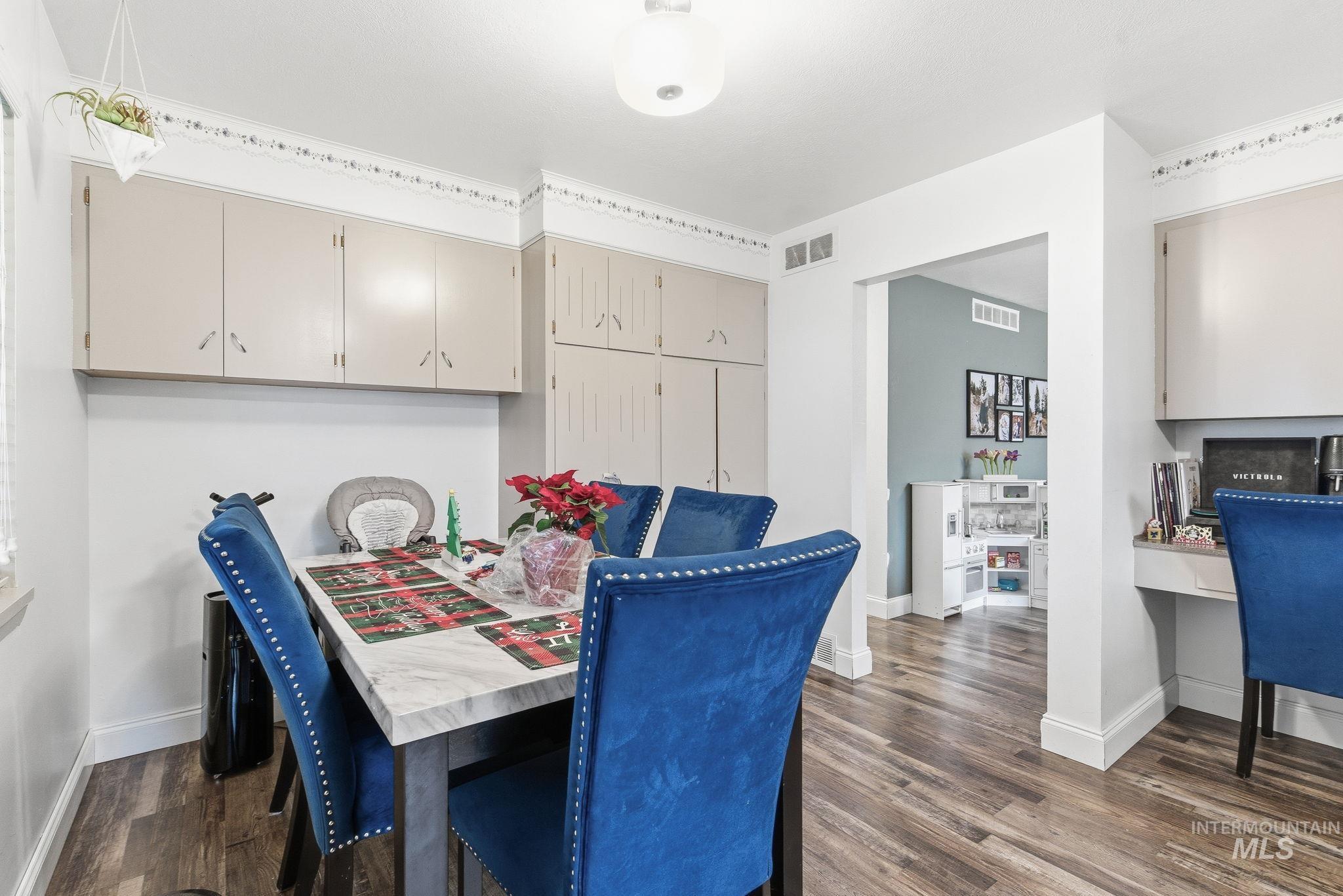 4426 West Clark Street Boise, ID 83705 - Photo 13 of 43 Dining area with dark wood-style floors and built in desk