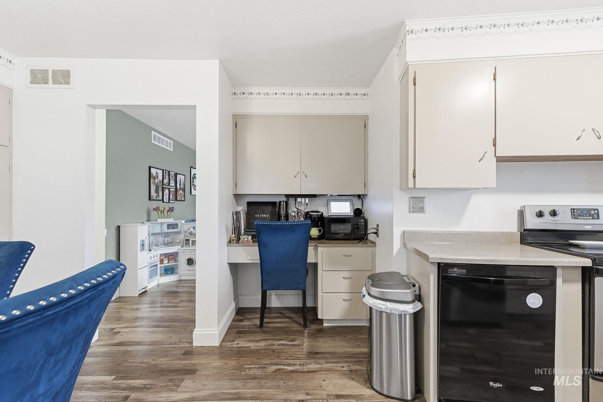 4426 West Clark Street Boise, ID 83705 - Photo 16 of 43 Kitchen featuring electric range, light countertops, black dishwasher, dark wood-style floors, and a desk