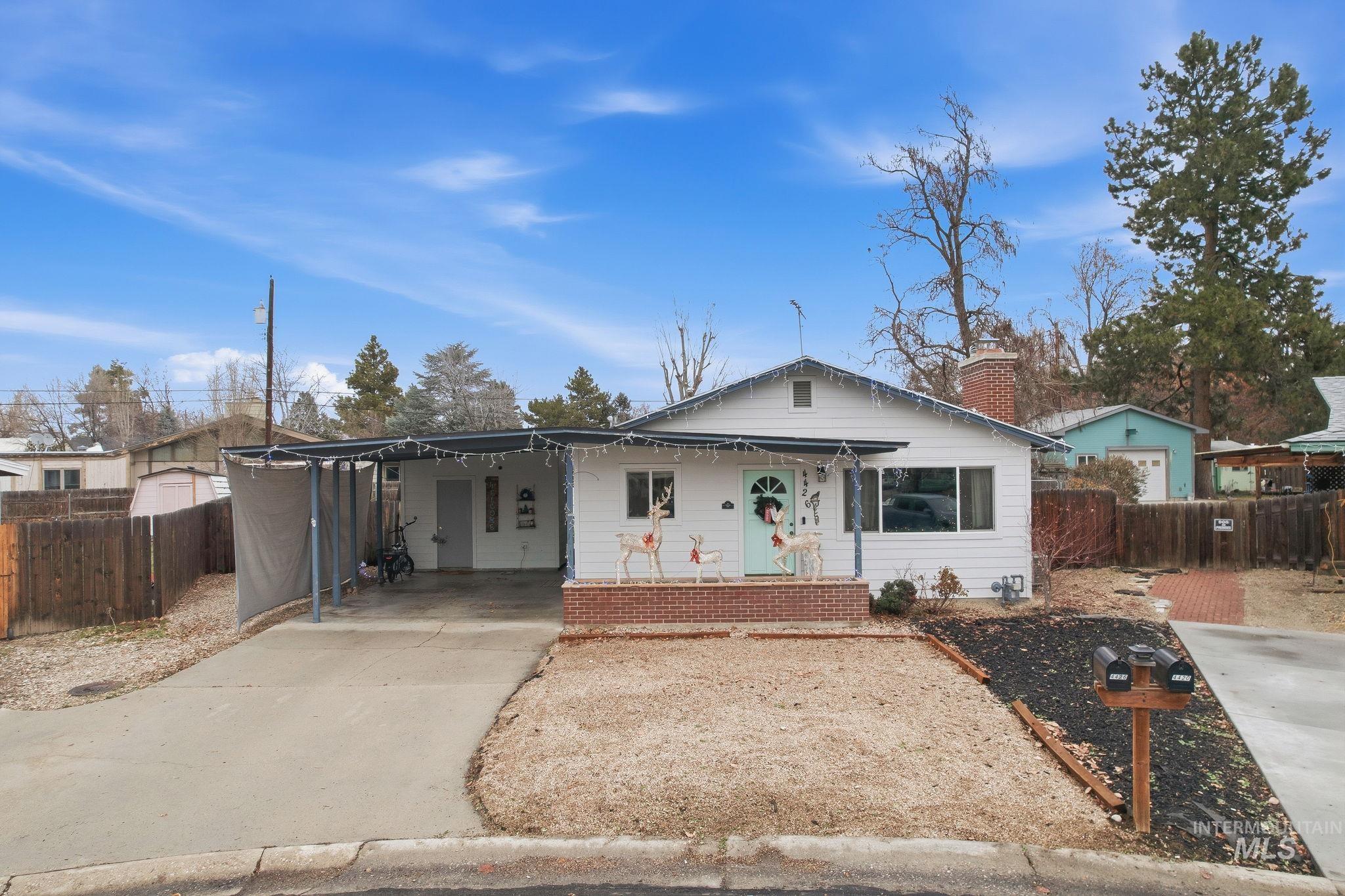 4426 West Clark Street Boise, ID 83705 - Photo 2 of 43 Bungalow-style house with covered porch, an attached carport, concrete driveway, and a chimney
