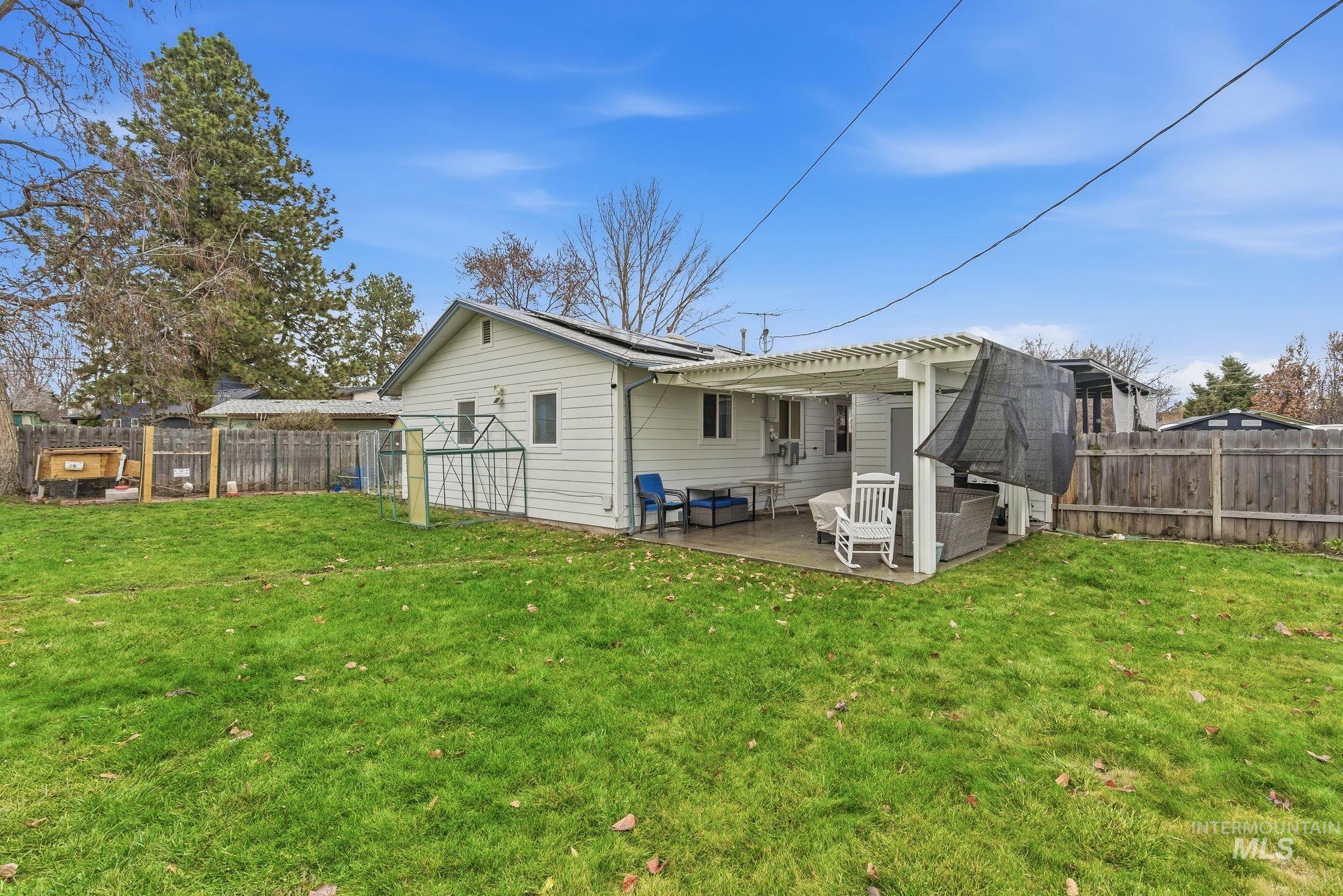 4426 West Clark Street Boise, ID 83705 - Photo 28 of 43 Back of property featuring a fenced backyard and a patio