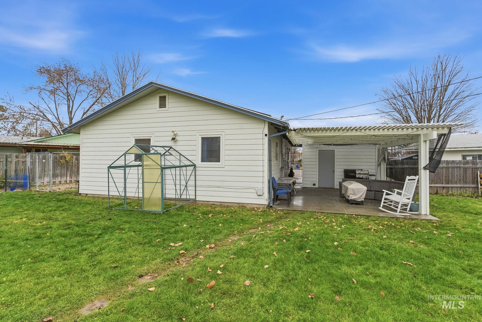 4426 West Clark Street Boise, ID 83705 - Photo 30 of 43 Back of house featuring a fenced backyard, a patio, and a pergola