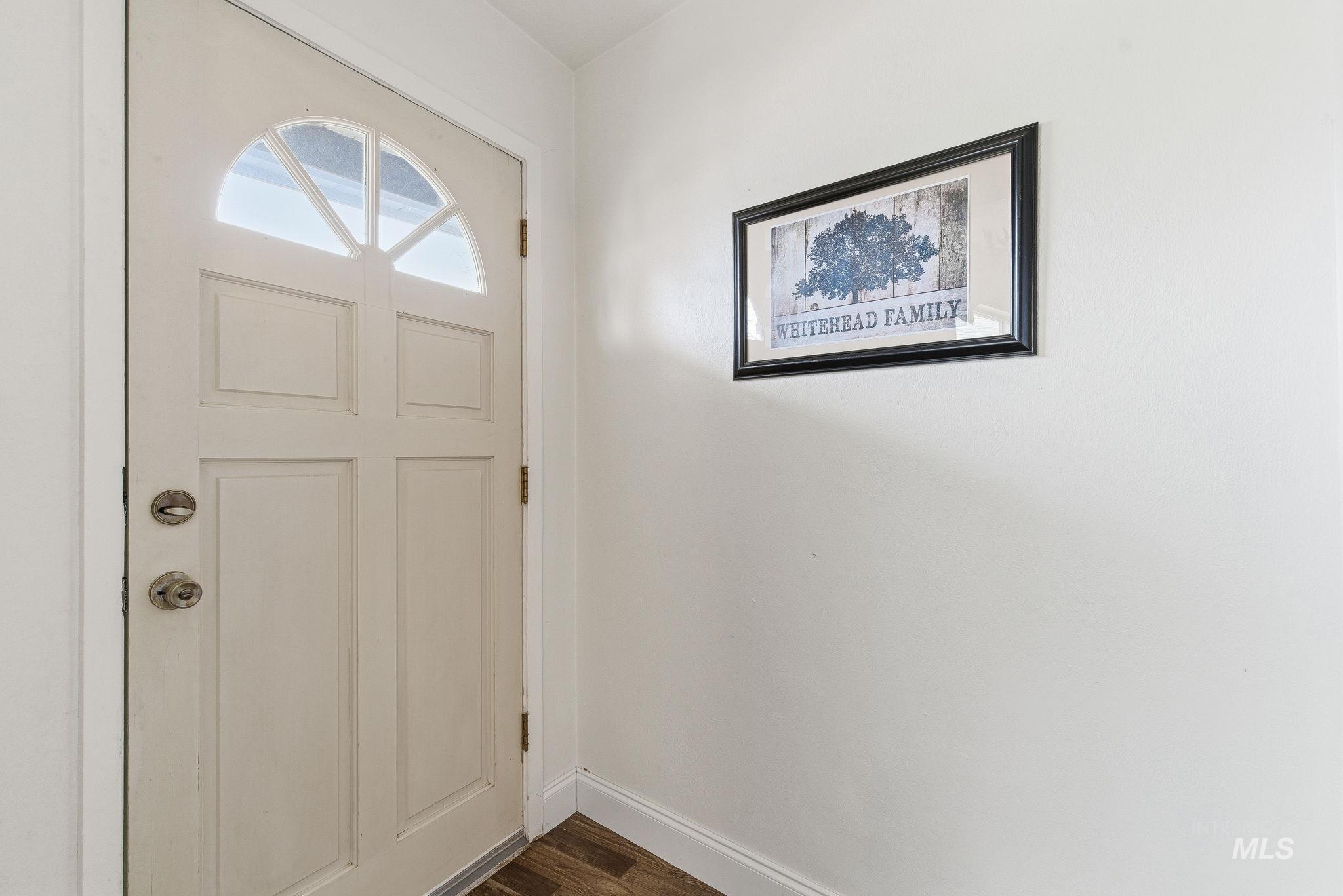 4426 West Clark Street Boise, ID 83705 - Photo 4 of 43 Foyer with dark wood finished floors and baseboards
