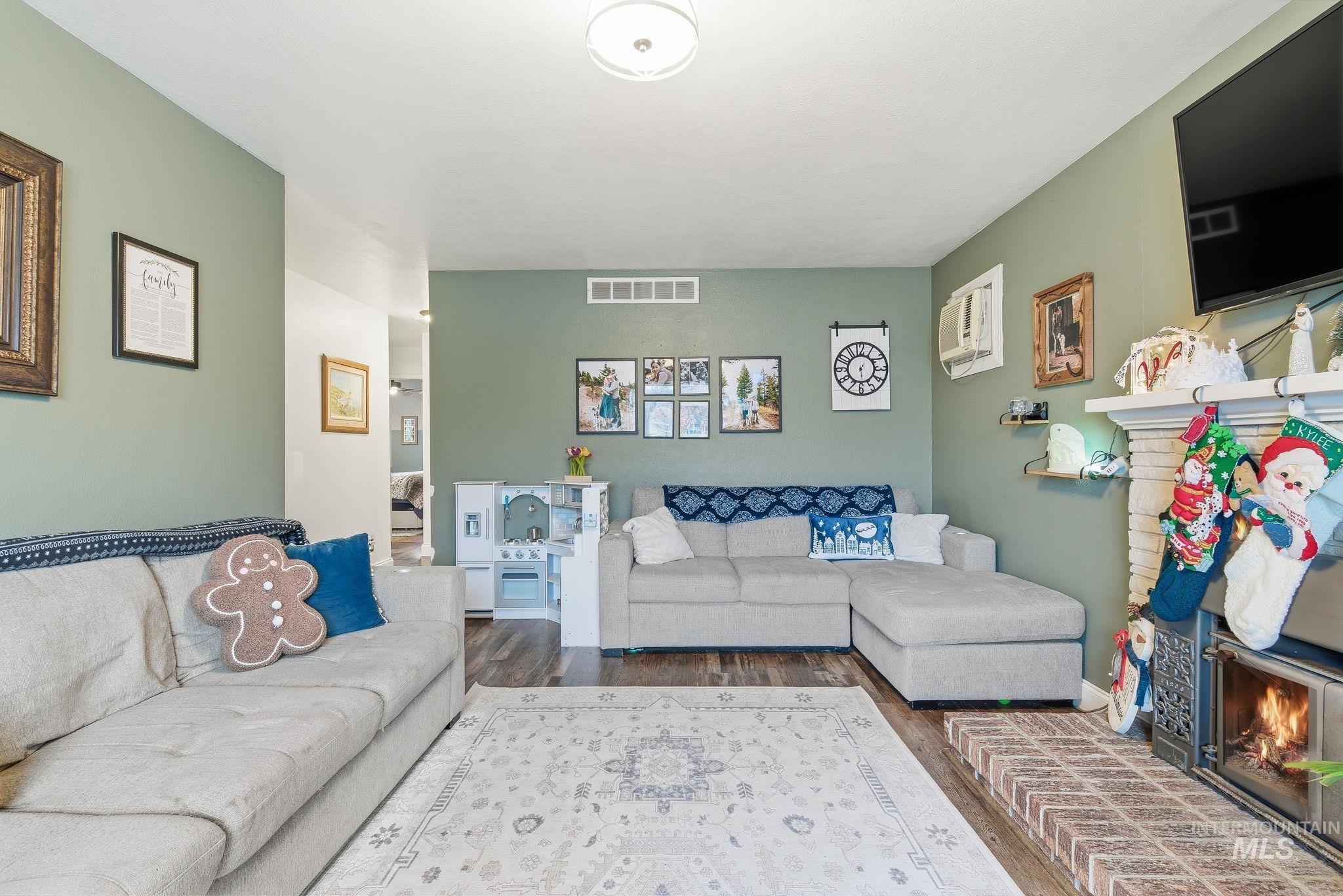 4426 West Clark Street Boise, ID 83705 - Photo 6 of 43 Living room with a brick fireplace and wood finished floors