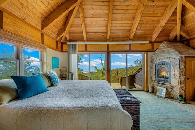 a bedroom with a large bed and a fireplace