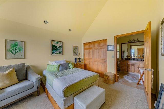 a bedroom with a bed and a couch