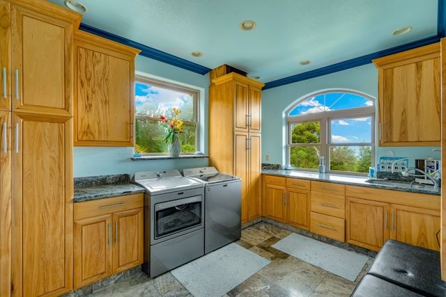 an aerial view of a house with a garden and lake view