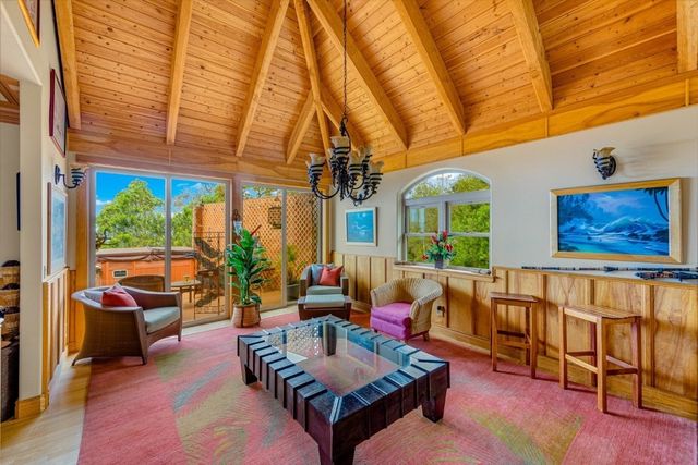 a living room with furniture a rug and a chandelier