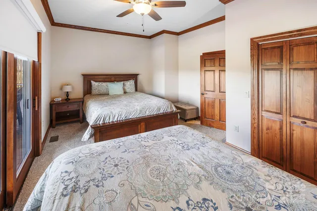a bedroom with a large bed and a chandelier