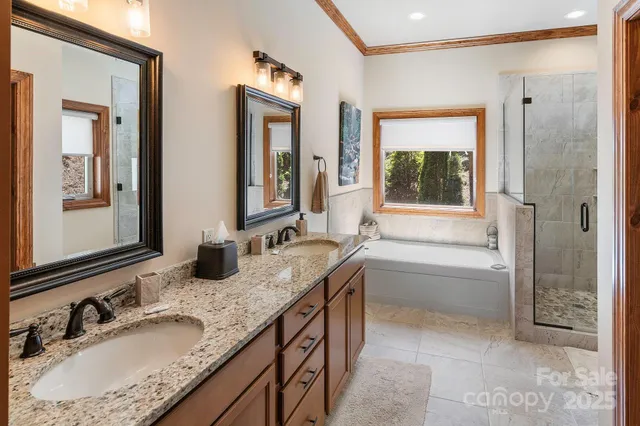a bathroom with a granite countertop tub sink and mirror