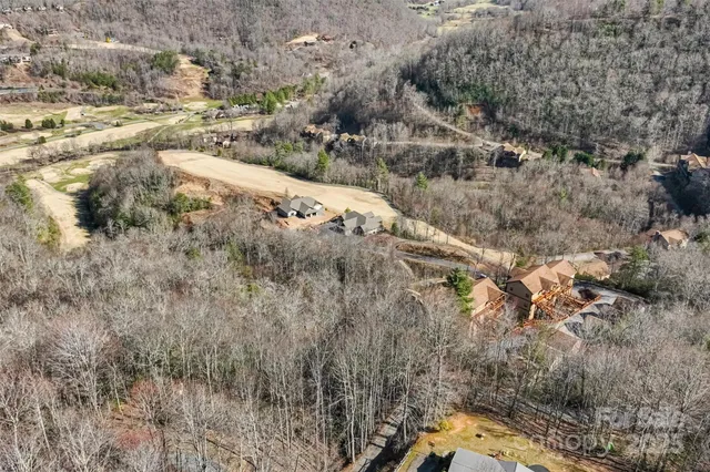 a view of a yard with wooden fence
