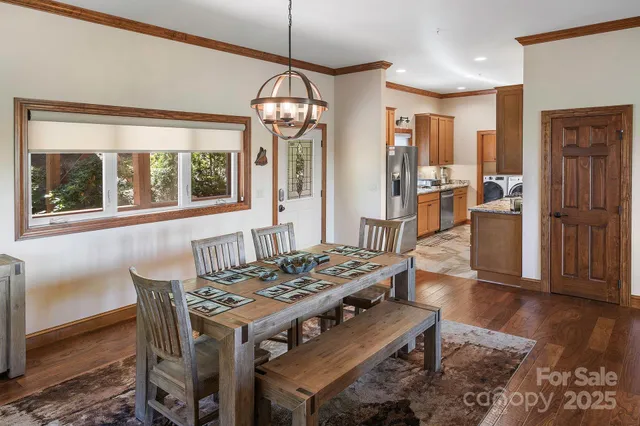 a view of a dining room with furniture wooden floor and chandelier