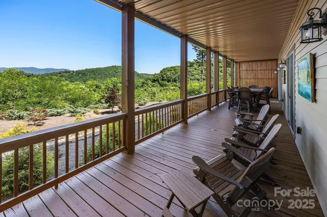 a view of a balcony with chairs and wooden floor