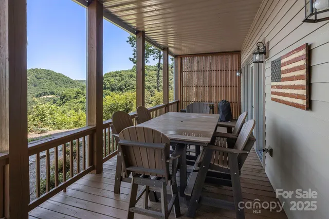 a view of balcony with wooden floor and outdoor seating